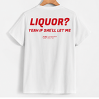 White short-sleeve t-shirt hanging on a wooden hanger, showing the back with bold red text that reads 'LIQUOR? YEAH IF SHE'LL LET ME' and a small red YUP logo underneath.