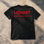 A black short-sleeve t-shirt laid flat on a textured concrete surface with dappled shadows. The back of the shirt features the phrase 'When you Excel They will spreadsheet about you' printed in a bold red font.