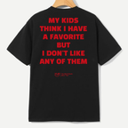 A black short-sleeve t-shirt hanging on a wooden hanger against a light gray background, showing the back with bold red text that reads 'MY KIDS THINK I HAVE A FAVORITE BUT I DON'T LIKE ANY OF THEM'.
