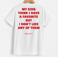 White short-sleeve T-shirt hanging on a wooden hanger, showing the back with bold red text that reads, 'MY KIDS THINK I HAVE A FAVORITE BUT I DON'T LIKE ANY OF THEM.' A small red YUB logo appears near the lower back.