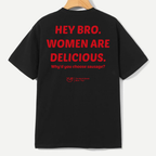A black short-sleeve t-shirt hanging on a wooden hanger, showing the back with bold red text that reads 'HEY BRO. WOMEN ARE DELICIOUS.