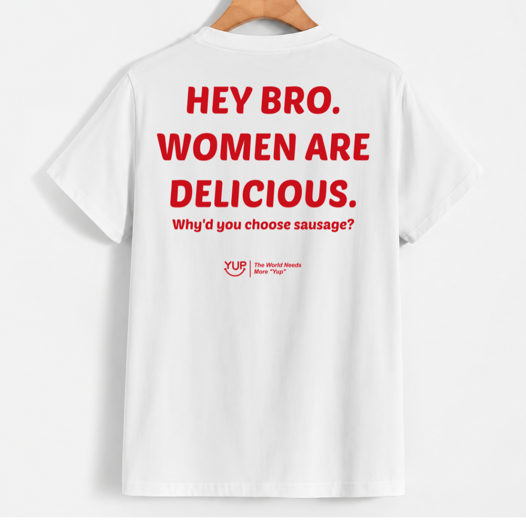 White short-sleeve T-shirt hanging on a wooden hanger against a light gray background, featuring large red text on the back that reads 'HEY BRO. WOMEN ARE DELICIOUS.