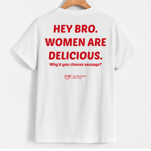 White short-sleeve T-shirt hanging on a wooden hanger against a light gray background, featuring large red text on the back that reads 'HEY BRO. WOMEN ARE DELICIOUS.