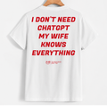 White short-sleeve t-shirt hanging on a wooden hanger, featuring bold red text on the back that reads 'I DON'T NEED CHATGPT MY WIFE KNOWS EVERYTHING' with a small red 'YUB' logo underneath.