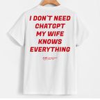 White short-sleeve t-shirt hanging on a wooden hanger, featuring bold red text on the back that reads 'I DON'T NEED CHATGPT MY WIFE KNOWS EVERYTHING' with a small red 'YUB' logo underneath.