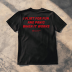 A black short-sleeve t-shirt laid flat on a textured concrete surface with dappled shadows. The back of the shirt features the phrase 'When you Excel They will spreadsheet about you' printed in a bold red font.