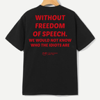 Black short-sleeve T-shirt hanging on a wooden hanger, showing the back with large red text that reads 'WITHOUT FREEDOM OF SPEECH. WE WOULD NOT KNOW WHO THE IDIOTS ARE' and a small red YUP logo near the lower back.