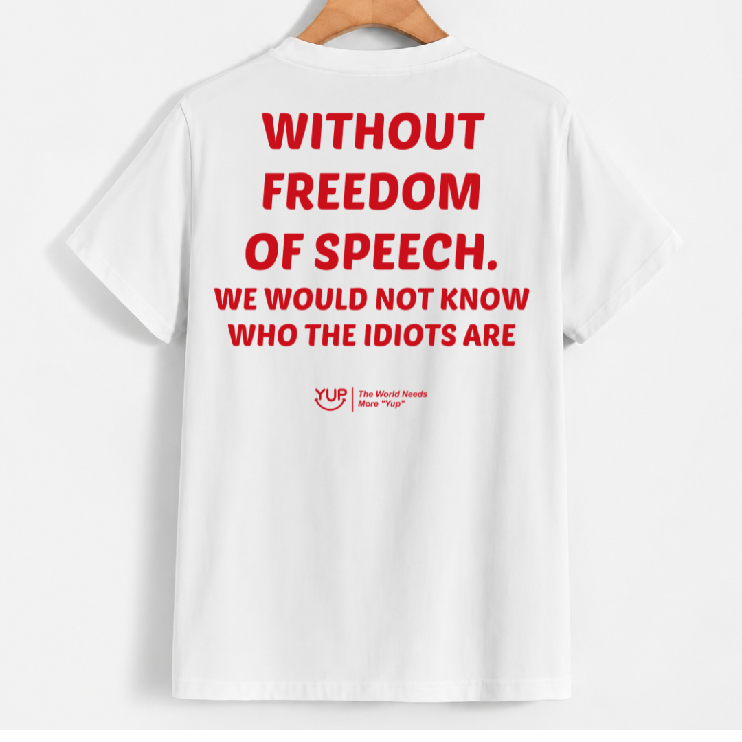White short-sleeve T-shirt hanging on a wooden hanger against a light gray background, showing the back with large red text reading 'WITHOUT FREEDOM OF SPEECH. WE WOULD NOT KNOW WHO THE IDIOTS ARE' and a small red YUR logo near the lower back.